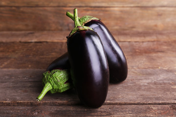 Fresh eggplant on wooden background © Africa Studio