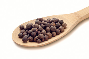 wooden spoon with black pepper isolated