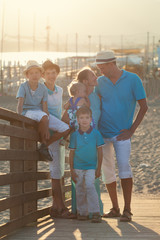 Happy beautiful family standing on bridge