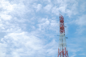 red and white color antenna repeater tower on blue sky