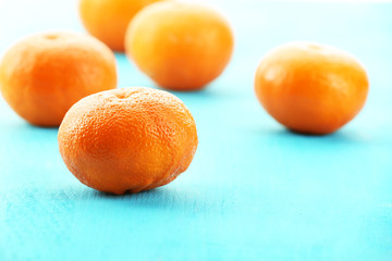 Ripe tangerines on wooden background