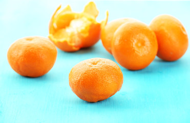 Ripe tangerines on wooden background