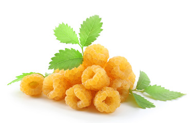 Yellow raspberries with green leaves isolated on white