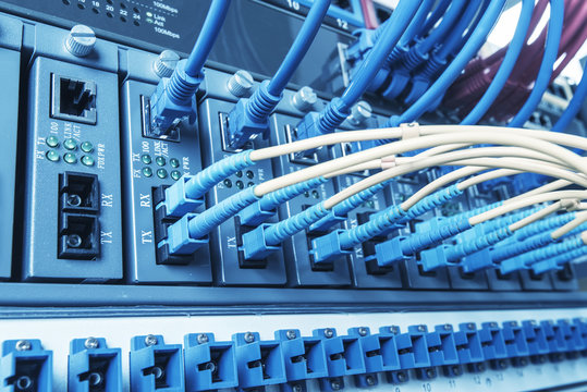 Fiber Optic cables connected to an optic ports and Network cable