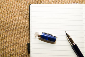 Opened notebook and pen on the old tissue
