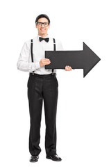 Elegant young man holding a big black arrow
