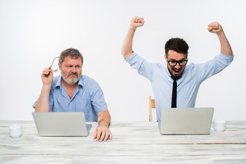 The two colleagues working together at office on white