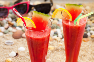 Summer vacation, watermelon juice and glasses on the beach