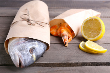 Dorado fish and other ingredients on wooden table, closeup