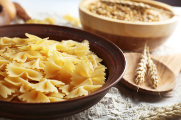 Preparing pasta with white flour and wheat on table, closeup