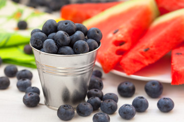 Fresh, organic, blueberries with watermelon slices in background