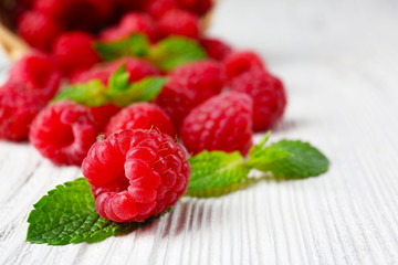 Fresh red raspberries on wooden table, closeup