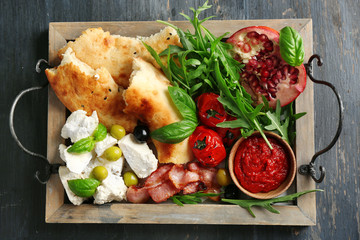 Ingredients of Mediterranean cuisine, on wooden tray, on wooden background