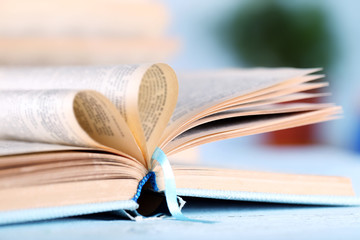 Pages of book curved into heart shape, close up