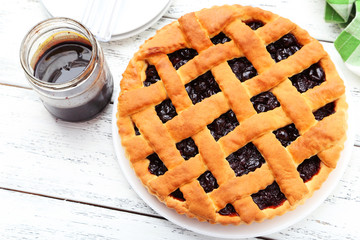 Homemade pie on white wooden background