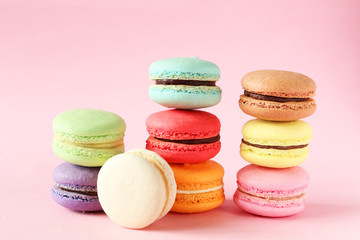 Fototapeta na wymiar French colorful macarons on pink background