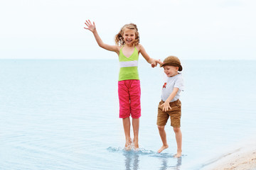 Little boy and girl jumping and having fun. Positive emotions.