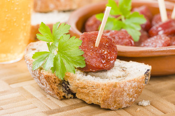 Chorizo a la Sidra - Spanish spicy chorizo sausages cooked in cider on top of crusty bread.

