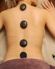 Obraz na płótnie Canvas Hot stone massage in spa salon