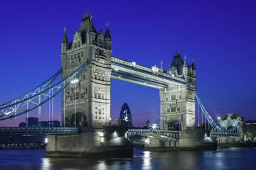 Illuminated Tower Bridge at night and the City of London, Englan