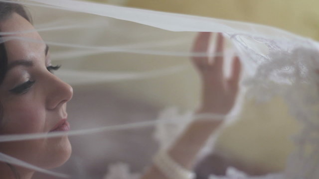 bride admires the veil