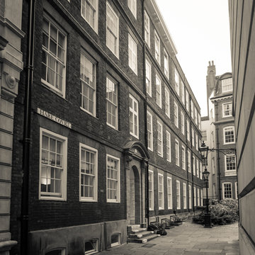 Hare Court, Temple, London. A retro styled sepia image of one of the small pedestrian streets that still display signs of Victorian London in the Temple area.