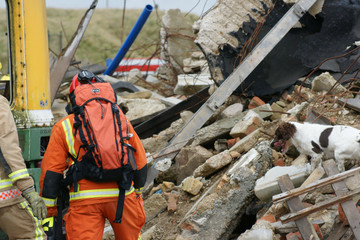 fire-fighters at building collapse disastor