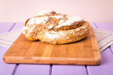 Homemade loaf of bread on cutting board