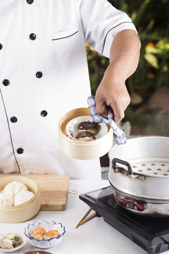 Chef Cooking Dumpling With Streamed Pot