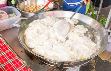 Thailand street food stir-fried squid eggs on the pan.
