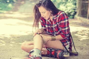 injured young woman suffering from pain sitting on the ground © pathdoc