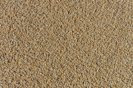 Hintergrund gelber Granit in Form von Splitt in mittlerer K&ouml;rnung