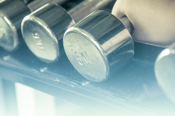 Asian male  hand grab dumbell  with soft light