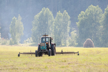 Tractor haymaking in the field