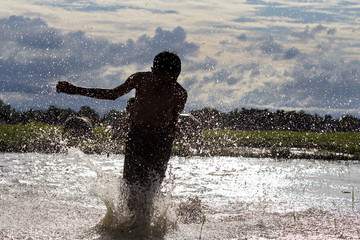 Boy running race silhouette on a swamp