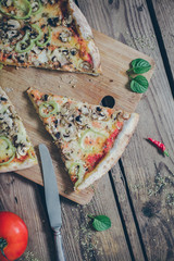 Vegetarian italian pizza on wodden table. Retro ,vintage filter.