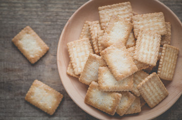 Mini coconut biscuit in wood plate on wood table background