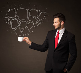 Businessman holding a white cup with speech bubbles