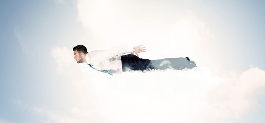 Business man flying like a superhero in clouds on the sky