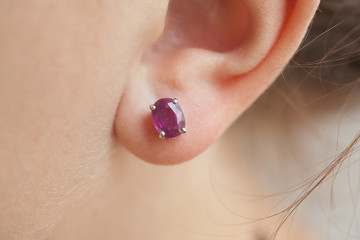 woman's ear with an earring