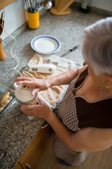 Elderly woman cooking in the kitchen