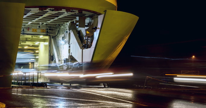 Cars and trucks exiting a big ferry boat.