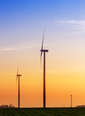 Fototapeta na wymiar Alternative energy concept, windmills at sunset.