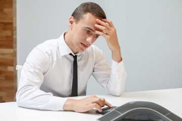 Angry businessman talks on the conference call in the office