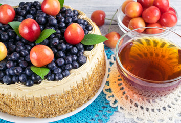 Celebratory cake with blueberries, sweet cherry, mint leaves and