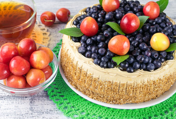 Celebratory cake with blueberries, sweet cherry, mint leaves and