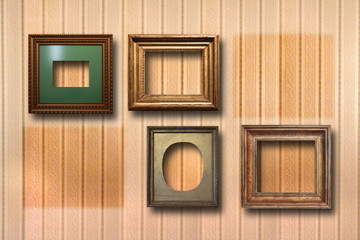 Fototapeta na wymiar Gilded wooden frames for pictures on background