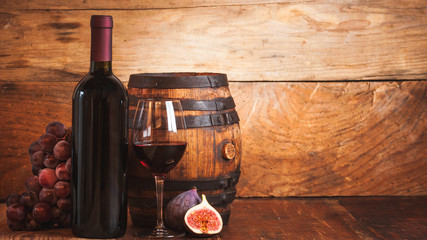 Fig with red wine, grape and barrel on rustic wood tabel