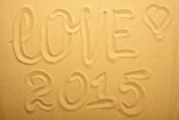 inscription love on the sand. Top view.