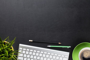 Office desk table with computer, flower and coffee cup